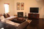 The living room offers a gas fireplace and large TV. Perfect for unwinding after a day on the mountain.